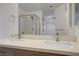 Bathroom featuring double sinks and a glass shower with backyard view at 205 Derwent Pl, Las Vegas, NV 89144