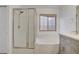 Bright bathroom with a soaking tub and a shower, along with decorative window for natural light at 205 Derwent Pl, Las Vegas, NV 89144