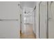 Hallway leading to bright bathroom with tiled floors, a glass shower, and backyard access at 205 Derwent Pl, Las Vegas, NV 89144