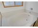 Close-up of bathtub with a decorative window and silver faucet at 205 Derwent Pl, Las Vegas, NV 89144