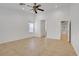 Empty bedroom features ceiling fan, neutral tile, and window at 205 Derwent Pl, Las Vegas, NV 89144
