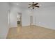 Empty bedroom with view of bathroom featuring neutral tile and ceiling fan at 205 Derwent Pl, Las Vegas, NV 89144