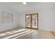 Bright bedroom featuring double doors to the back and tile flooring, providing a serene retreat at 205 Derwent Pl, Las Vegas, NV 89144