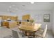 Open dining area with a wooden table set, adjacent to a bright kitchen with modern appliances at 205 Derwent Pl, Las Vegas, NV 89144