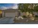 Charming single-story home with a well-maintained front yard and a two-car garage at 205 Derwent Pl, Las Vegas, NV 89144