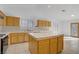 Open kitchen with a center island, tile countertops, and light wood cabinets at 205 Derwent Pl, Las Vegas, NV 89144
