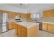 Functional kitchen with wood cabinets, tile countertops, and stainless steel appliances at 205 Derwent Pl, Las Vegas, NV 89144
