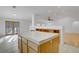 A kitchen island is adjacent to the living room with hardwood floors at 205 Derwent Pl, Las Vegas, NV 89144