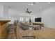 Bright, neutrally decorated living room with hardwood floors, a ceiling fan, and a view of the exterior at 205 Derwent Pl, Las Vegas, NV 89144