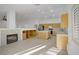 Open-concept living space with a fireplace, kitchen, and tile flooring, creating an inviting atmosphere at 205 Derwent Pl, Las Vegas, NV 89144