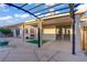 Covered patio with an outdoor grill and desert landscaping. The pool is also visible at 205 Derwent Pl, Las Vegas, NV 89144