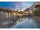 Resort-style pool with lush landscaping and covered patio, perfect for outdoor entertaining and relaxation at 205 Derwent Pl, Las Vegas, NV 89144