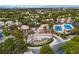 Expansive aerial view of the community with a tranquil pond, lush greenery, tennis courts, and a welcoming entrance fountain at 2050 W Warm Springs Rd # 1822, Henderson, NV 89014