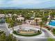 Aerial view of the community featuring tennis courts, a pool, water features, desert landscaping, and lush greenery at 2050 W Warm Springs Rd # 1822, Henderson, NV 89014