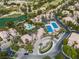 Aerial view of community featuring tennis courts, a pool, water features, desert landscaping, and lush greenery at 2050 W Warm Springs Rd # 1822, Henderson, NV 89014