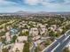 Aerial view of the community featuring lush greenery, desert landscaping, golf course, and mountain views at 2050 W Warm Springs Rd # 1822, Henderson, NV 89014