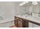Bright bathroom with combined tub and shower, white tile surround and spacious countertop at 2050 W Warm Springs Rd # 1822, Henderson, NV 89014