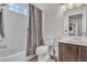 Bright bathroom featuring a shower-tub combo with tiled walls and a vanity with modern fixtures at 2050 W Warm Springs Rd # 1822, Henderson, NV 89014