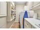 Well-lit laundry room features white cabinets, countertop space, and a washer-dryer set at 2050 W Warm Springs Rd # 1822, Henderson, NV 89014