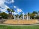 Beautiful community water feature with tiered stone planters, fountains, palm trees, and a clear blue sky at 2050 W Warm Springs Rd # 1822, Henderson, NV 89014