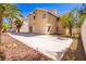 Backyard with a large patio, desert landscaping, and rear elevation of the house at 2105 Harbor Cliff Dr, Las Vegas, NV 89128