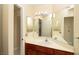 Functional bathroom with a large mirror, single sink vanity, and neutral color scheme at 2105 Harbor Cliff Dr, Las Vegas, NV 89128
