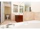 Bathroom featuring a cherry wood vanity and white soaking tub at 2105 Harbor Cliff Dr, Las Vegas, NV 89128