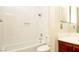 Clean bathroom showcasing white tiled shower and bath, plus dark wood vanity at 2105 Harbor Cliff Dr, Las Vegas, NV 89128