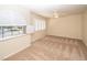 Bright carpeted bedroom with fan, shuttered window, and neutral walls at 2105 Harbor Cliff Dr, Las Vegas, NV 89128