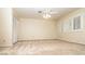 Spacious bedroom with ceiling fan, bright window shutters, and closet with sliding doors at 2105 Harbor Cliff Dr, Las Vegas, NV 89128