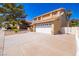 Wide driveway leading to a well-maintained two-story home with an attached two-car garage at 2105 Harbor Cliff Dr, Las Vegas, NV 89128