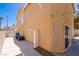 Side view of the home's exterior featuring AC units and a concrete patio at 2105 Harbor Cliff Dr, Las Vegas, NV 89128