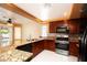 Modern kitchen featuring granite countertops, stainless steel appliances, and a neutral color scheme at 2105 Harbor Cliff Dr, Las Vegas, NV 89128