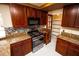 Well-equipped kitchen with stainless steel appliances, custom cabinets, granite countertops and walk-in pantry at 2105 Harbor Cliff Dr, Las Vegas, NV 89128