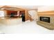 Open floor plan showcasing a fireplace, staircase, and view into the kitchen, with white tile floors at 2105 Harbor Cliff Dr, Las Vegas, NV 89128