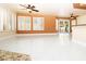 Spacious living area featuring white tile floors, multiple windows, and a view into the kitchen at 2105 Harbor Cliff Dr, Las Vegas, NV 89128