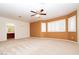 Spacious bedroom featuring a ceiling fan, bay window, and plush carpeting at 2105 Harbor Cliff Dr, Las Vegas, NV 89128