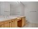 Bathroom featuring double sinks, wood cabinetry, and a large mirror at 232 Morgyn Ln # 6, Boulder City, NV 89005
