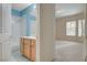 Bathroom view with a tub-shower, single vanity, and neutral tile flooring at 232 Morgyn Ln # 6, Boulder City, NV 89005