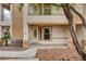 Inviting front entrance featuring a private balcony, tan stucco and decorative stone accents at 232 Morgyn Ln # 6, Boulder City, NV 89005