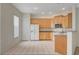 Bright kitchen featuring white appliances, tile flooring, and ample cabinet space at 232 Morgyn Ln # 6, Boulder City, NV 89005