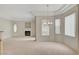 Bright living room with neutral carpet, cozy fireplace, and natural light from multiple windows at 232 Morgyn Ln # 6, Boulder City, NV 89005