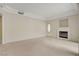 Spacious living room with neutral carpet, cozy fireplace, and a well-lit, open layout at 232 Morgyn Ln # 6, Boulder City, NV 89005