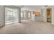 Open-concept living space with carpeted floors flowing into the kitchen area at 232 Morgyn Ln # 6, Boulder City, NV 89005