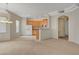 Open-concept living room showcasing natural light, chandelier and access to the kitchen area at 232 Morgyn Ln # 6, Boulder City, NV 89005