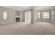 Bright living room with neutral carpet, cozy fireplace, and natural light from multiple windows at 232 Morgyn Ln # 6, Boulder City, NV 89005