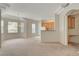 Open-concept living space with carpeted floors flowing into the kitchen area at 232 Morgyn Ln # 6, Boulder City, NV 89005