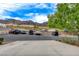 Community parking area with multiple vehicles and mountain views at 232 Morgyn Ln # 6, Boulder City, NV 89005