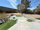 Backyard featuring a beautiful pond, rock accents, and a well-manicured yard at 2429 Worchester Rd, Henderson, NV 89074