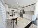 Modern kitchen featuring stainless steel appliances, white cabinets, and marble countertops at 2429 Worchester Rd, Henderson, NV 89074